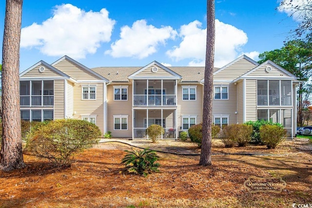 rear view of property featuring a sunroom