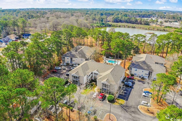 bird's eye view with a forest view and a water view