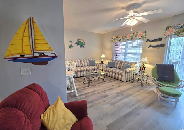 living room featuring ceiling fan and wood finished floors