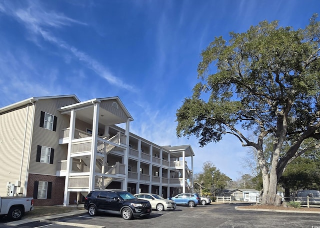 view of building exterior with uncovered parking