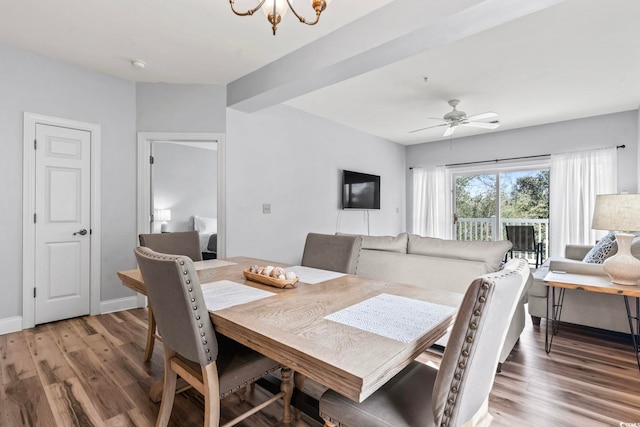 dining area with ceiling fan with notable chandelier and wood finished floors