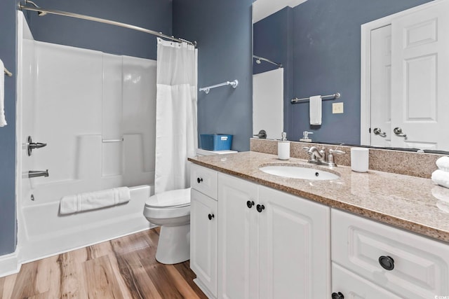 full bathroom with toilet, vanity, wood finished floors, and shower / bath combination with curtain