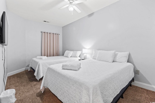 carpeted bedroom featuring ceiling fan, baseboards, and visible vents