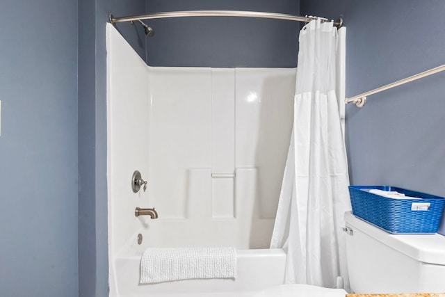 bathroom featuring toilet and shower / bath combination with curtain