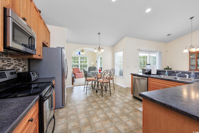286 Bonnie Bridge Cir, Myrtle Beach, SC 29579 - kitchen with appliances with stainless steel finishes, a chandelier, a sink, dark countertops, and vaulted ceiling