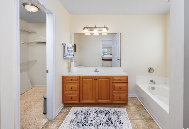 286 Bonnie Bridge Cir, Myrtle Beach, SC 29579 - bathroom featuring vanity, a bath, connected bathroom, a spacious closet, and baseboards