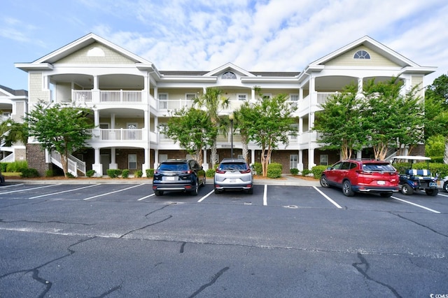 view of building exterior with uncovered parking