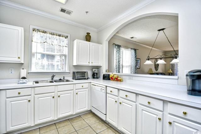 kitchen with crown molding, light countertops, visible vents, white dishwasher, and a sink