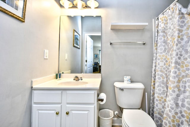 bathroom featuring toilet, a shower with curtain, and vanity