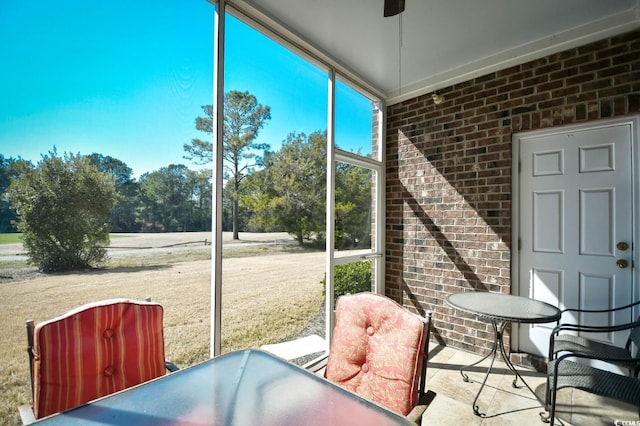 sunroom / solarium with a ceiling fan