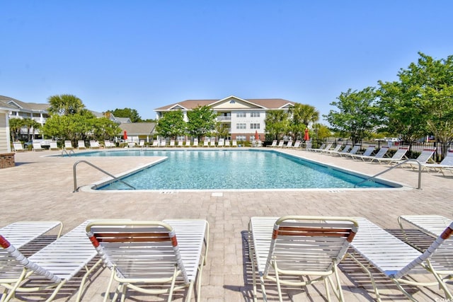 pool with fence and a patio