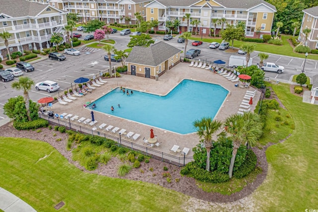 view of swimming pool featuring a patio area and fence