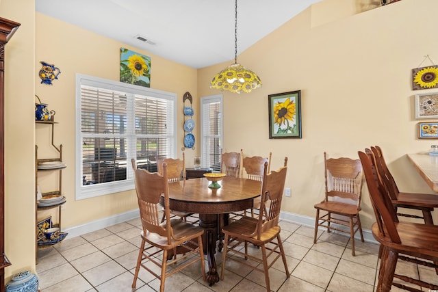 dining space featuring baseboards, visible vents, and light tile patterned flooring