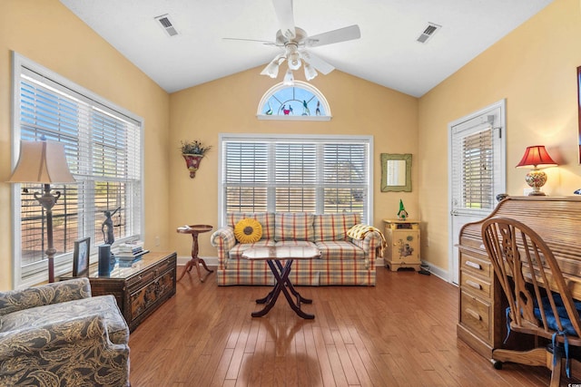 office area with lofted ceiling, visible vents, hardwood / wood-style flooring, and a ceiling fan