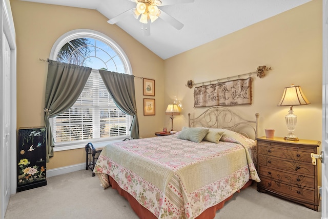 carpeted bedroom featuring vaulted ceiling, baseboards, and ceiling fan