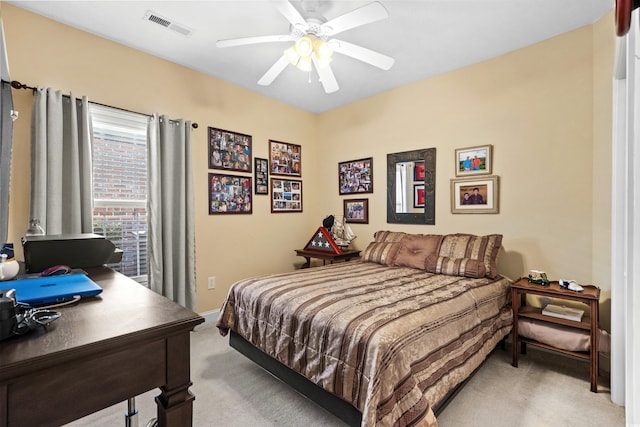 carpeted bedroom with visible vents and a ceiling fan