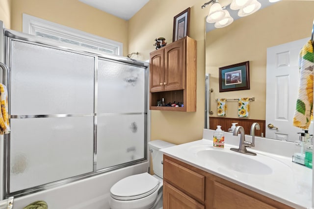 bathroom featuring shower / bath combination with glass door, vanity, and toilet