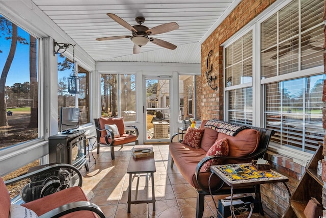 sunroom / solarium with lofted ceiling, a wealth of natural light, and a ceiling fan