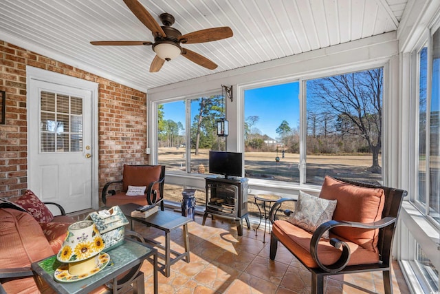 sunroom / solarium with wood ceiling and ceiling fan