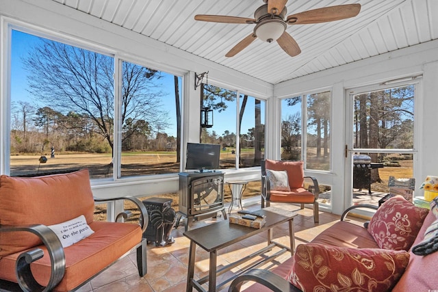 sunroom / solarium featuring vaulted ceiling, wood ceiling, and a ceiling fan