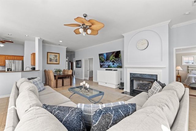 4517 Planters Row Way, Myrtle Beach, SC 29579 - living room featuring baseboards, ceiling fan, a premium fireplace, and crown molding