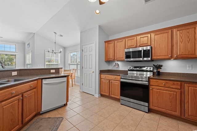 4517 Planters Row Way, Myrtle Beach, SC 29579 - kitchen featuring dark countertops, lofted ceiling, a sink, and stainless steel appliances
