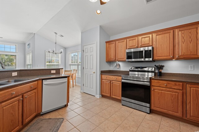 4517 Planters Row Way, Myrtle Beach, SC 29579 - kitchen featuring appliances with stainless steel finishes, dark countertops, vaulted ceiling, brown cabinets, and recessed lighting