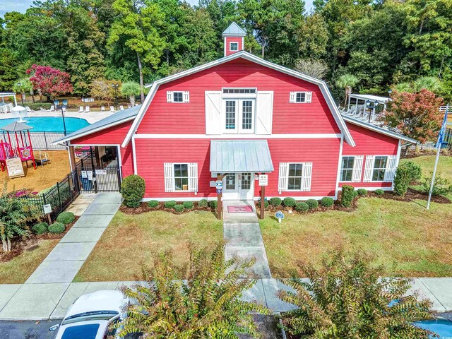 4517 Planters Row Way, Myrtle Beach, SC 29579 - dutch colonial featuring a gambrel roof, french doors, a community pool, and a gate