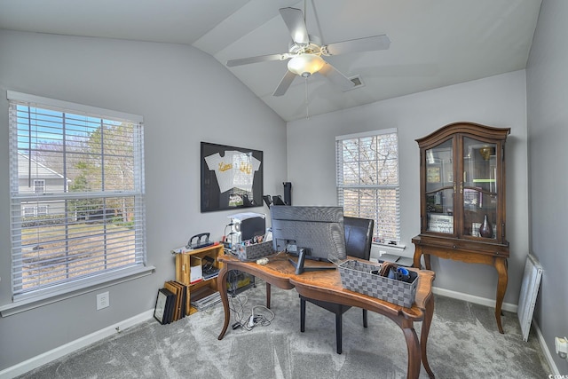 carpeted office featuring lofted ceiling, a ceiling fan, visible vents, and baseboards