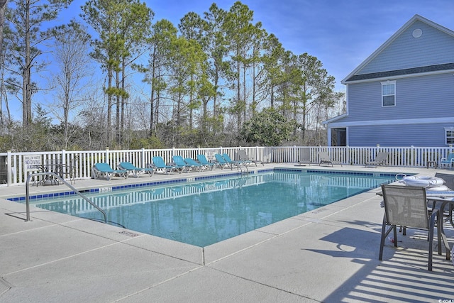 pool featuring a patio area and fence