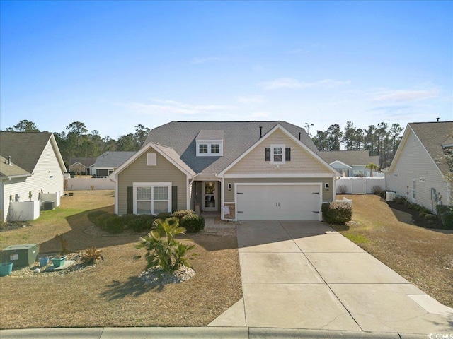 view of front of property featuring driveway and fence