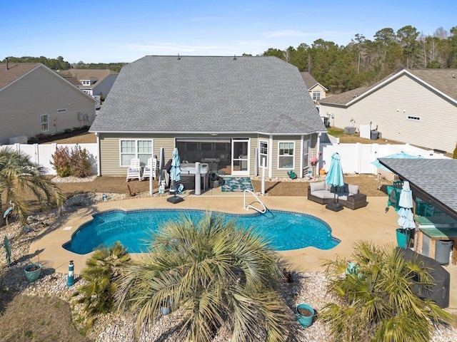 back of property with a patio, a fenced backyard, a sunroom, and a fenced in pool