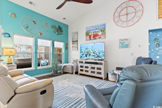 living area with high vaulted ceiling, ceiling fan, visible vents, and wood finished floors