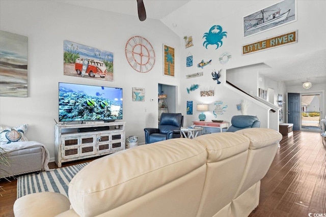 living area with high vaulted ceiling and dark wood-type flooring