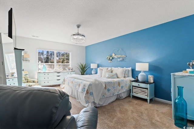 carpeted bedroom with a textured ceiling and baseboards