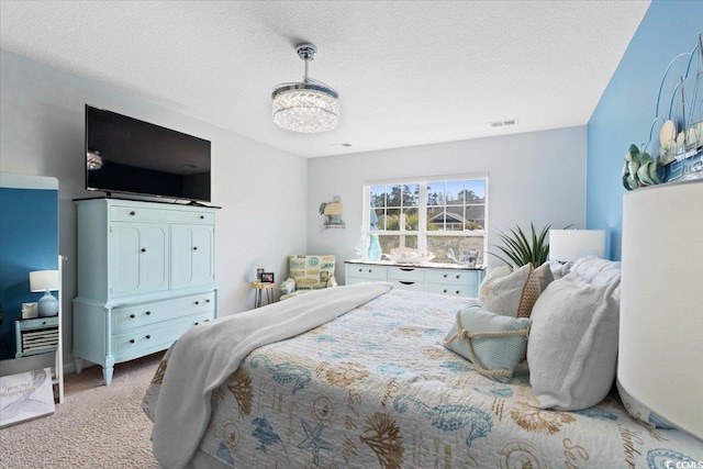 bedroom with visible vents, a chandelier, a textured ceiling, and light colored carpet