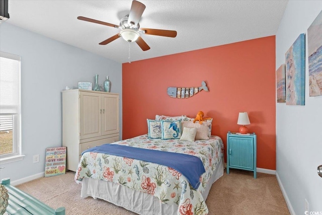 carpeted bedroom featuring a ceiling fan and baseboards