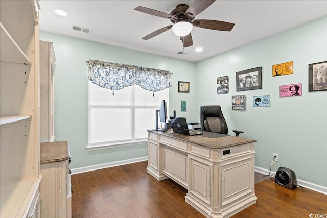 office area with ceiling fan, dark wood finished floors, visible vents, and baseboards