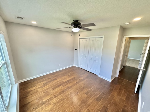 556 Cedar Lakes Dr, Little River, SC 29566 - unfurnished bedroom with dark wood-type flooring, a textured ceiling, a closet, and ceiling fan