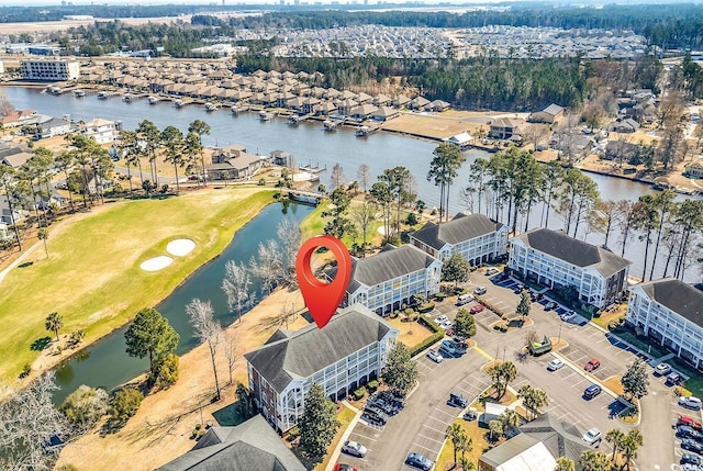 birds eye view of property featuring a water view and golf course view