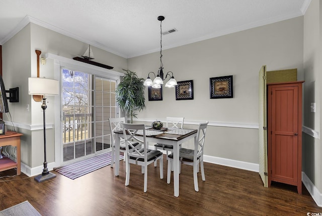 dining area with baseboards, ornamental molding, a chandelier, and dark wood-type flooring