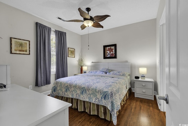 bedroom with a ceiling fan, dark wood-style floors, and visible vents
