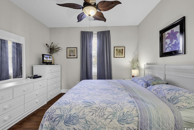 bedroom with baseboards, a ceiling fan, and dark wood-style flooring