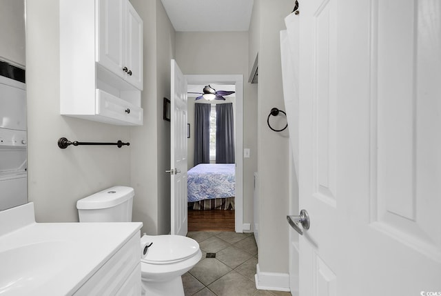 bathroom featuring tile patterned flooring, vanity, toilet, a ceiling fan, and baseboards