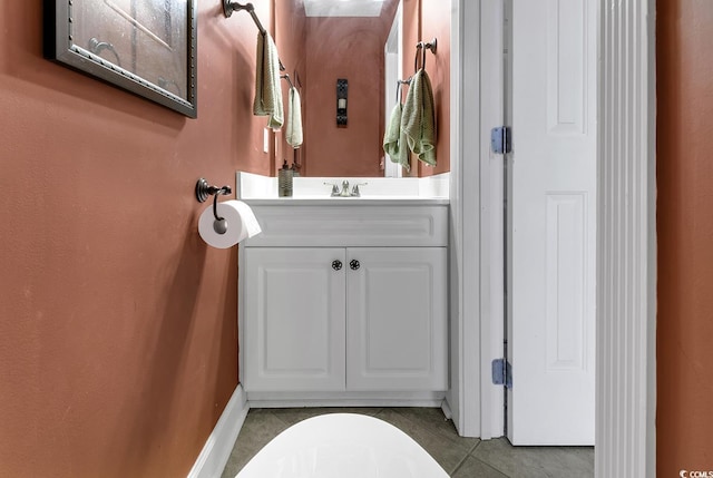 bathroom with tile patterned floors, baseboards, and vanity