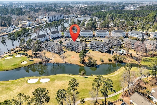 birds eye view of property featuring view of golf course and a water view
