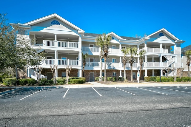 view of building exterior featuring uncovered parking