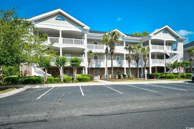 5801 Oyster Catcher Dr Unit 723, North Myrtle Beach, SC 29582 - view of building exterior featuring stairs and uncovered parking