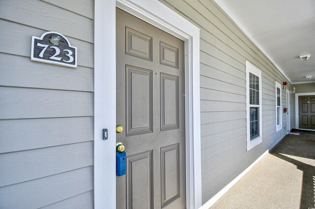 5801 Oyster Catcher Dr Unit 723, North Myrtle Beach, SC 29582 - corridor featuring light tile patterned floors, arched walkways, and baseboards