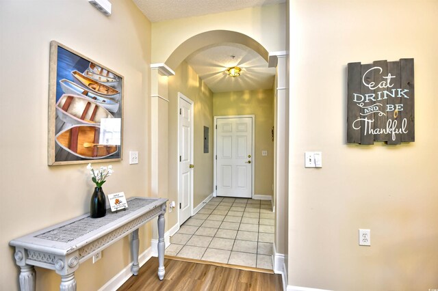 5801 Oyster Catcher Dr Unit 723, North Myrtle Beach, SC 29582 - kitchen with white appliances, light countertops, white cabinets, arched walkways, and light tile patterned floors